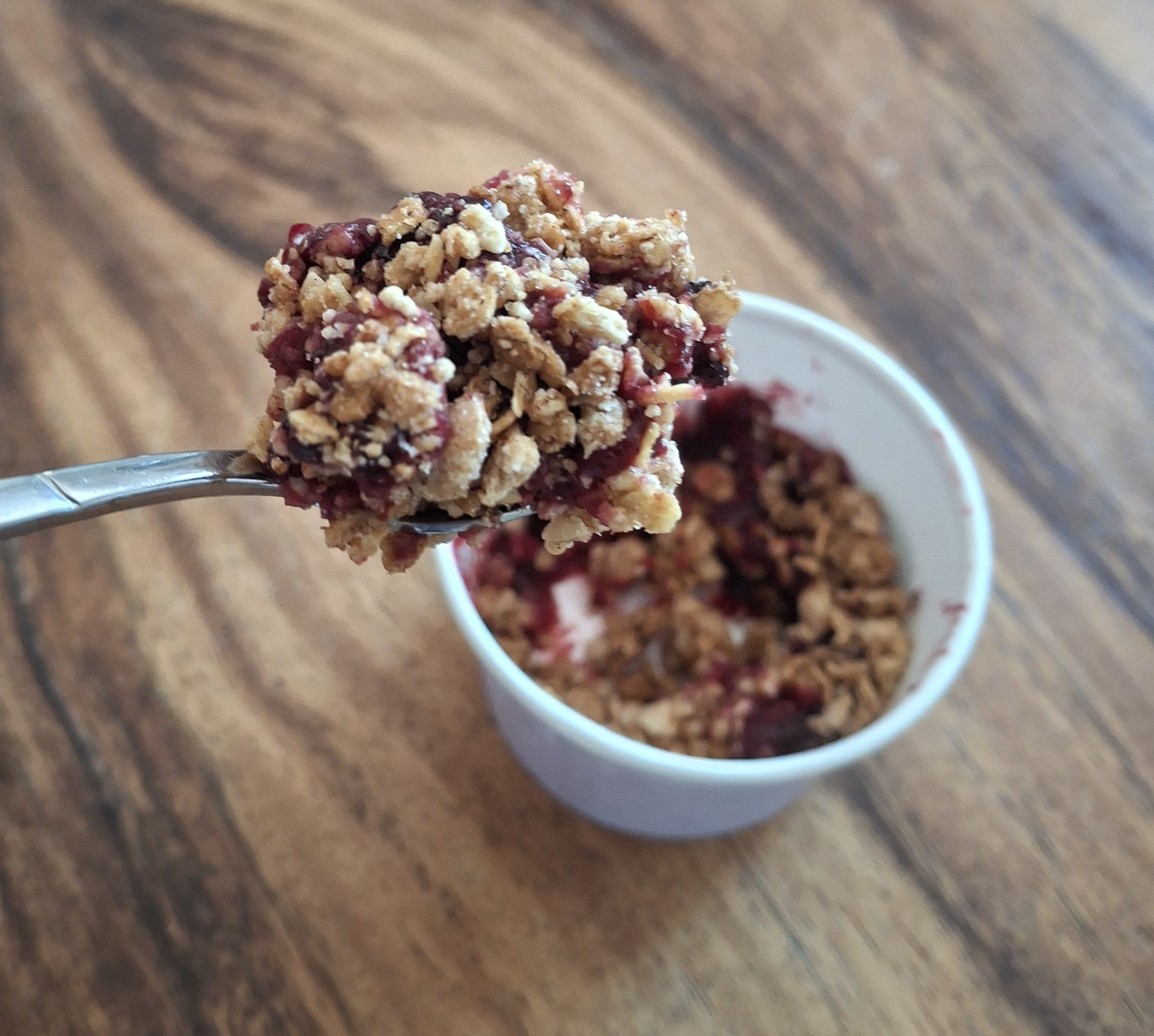 A spoonful of CrumbleNess crumble with a crunchy oat topping